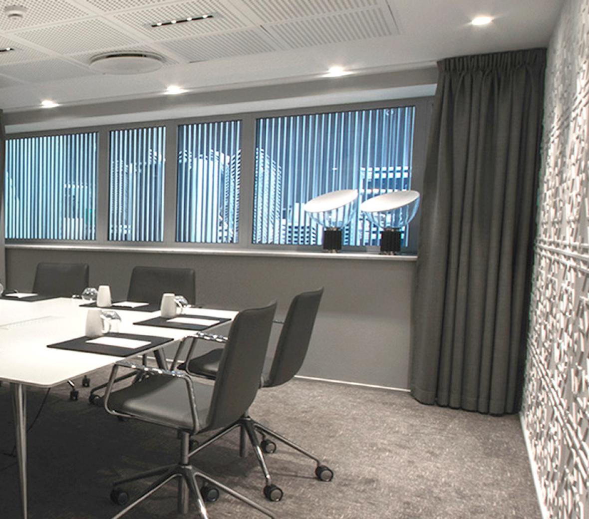 An elegantly decorated meeting room complete with a large center table with space for eight.