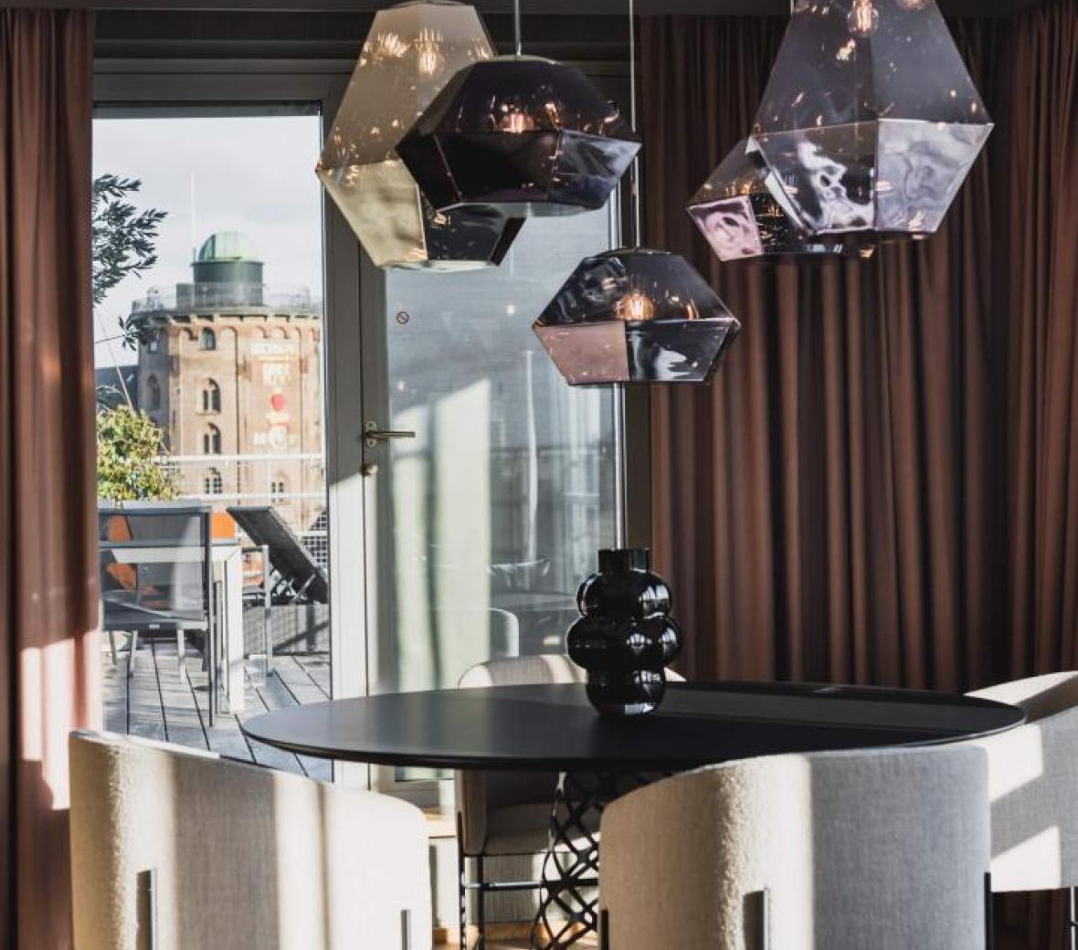A dining table in a hotel suite overlooking Copenhagen